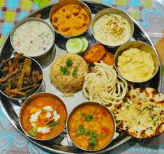 a metal plate topped with different types of food