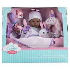 a baby doll in a box with stuffed animals