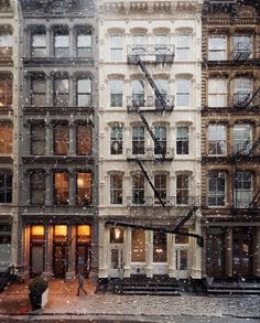 an image of a building in the snow with fire escapes on it's side