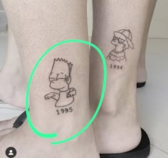 two people with tattoos on their legs and one has a green circle around the foot