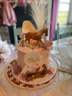 there is a cake that has horses on it and flowers in the shape of a horse