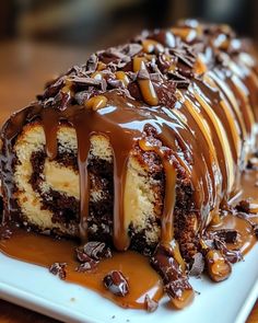 a piece of cake covered in chocolate and drizzled with caramel