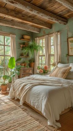 a bed sitting in a bedroom next to two windows with potted plants on them