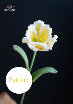 a white and yellow flower with the words pattern on it