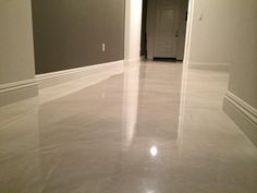 an empty room with white walls and flooring in the middle is shown from the hallway