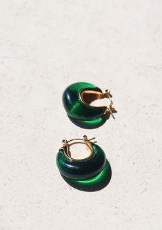 Introducing our enchanting A Thousand Island Earrings - a mesmerising homage to the lush beauty of nature, crafted with the finest deep green emerald. These curve-shaped earrings with mini gold hoops are wearable treasures inspired by the verdant islands, the tranquillity of a hidden paradise, and the timeless allure of nature's wonders. Material: Stainless Steel Waterproof: Yes Hypoallergenic: Suitable for sensitive skin Durability: Non-tarnish Each of our products is beautifully packaged in an elegant, reusable, and recyclable jewellery box, ready for gifting. Green Earrings For May Birthstone, Green Round Earrings For May Birthstone, Modern Green Handmade Jewelry, Green Handmade Modern Jewelry, Modern Handmade Green Jewelry, Handmade Modern Green Jewelry, Modern Green Round Earrings, Modern Green Emerald Jewelry, Elegant Small Hoop Emerald Earrings