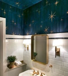 a white sink sitting under a bathroom mirror