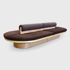 a couch with two pillows on it and a wooden frame around the backrests