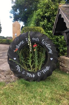 there is a tire with flowers in it