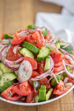 cucumber tomato salad in a white bowl with text overlay that reads, cucumber tomato salad done in 10 minutes easy dill dressing