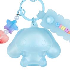 an elephant keychain with two charms attached to it's back and the other one