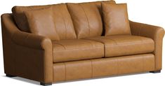 a brown leather couch with two pillows on it's back and armrests