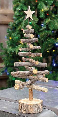 a small christmas tree made out of logs