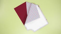 two red and white napkins sitting on top of each other