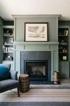 a living room filled with furniture and a fire place in front of a book shelf