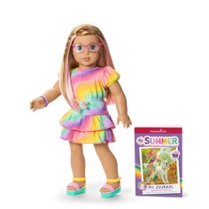 a doll with glasses and a book next to it on a white background, the doll is wearing a rainbow colored dress