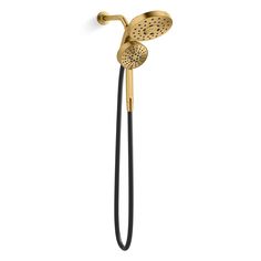 the shower head and handset are gold with black handles, which is attached to a wall