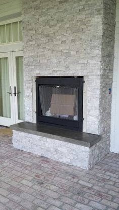 a brick fireplace in the middle of a patio