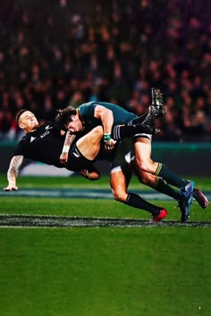 two rugby players colliding for the ball during a game