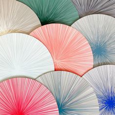 many different colored parasols are arranged in the same pattern as they appear to be folded