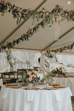 the table is set with plates and place settings