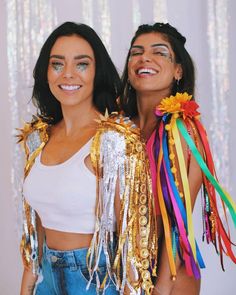 two women are dressed up and smiling for the camera