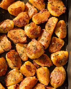 roasted potatoes with herbs and seasoning in a baking pan