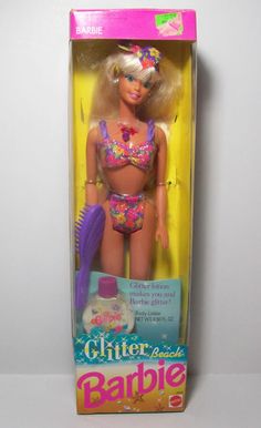 a barbie doll in a bathing suit and hair brush