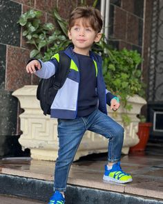 a young boy is standing on the steps