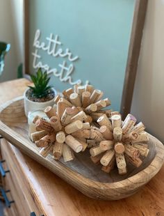 a wooden tray filled with wine corks and a potted plant