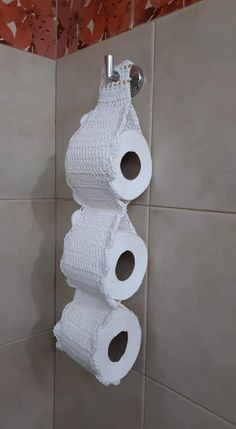 two rolls of toilet paper are hanging on the wall