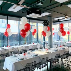 tables set up with white and red balloons