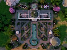 an aerial view of a park with many trees and buildings in the middle of it