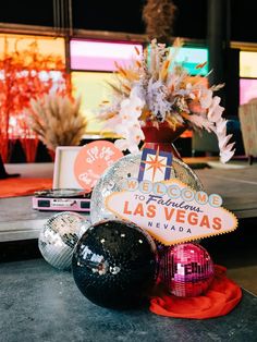 the las vegas sign and disco balls are on display