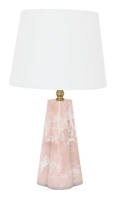 a pink lamp with a white shade on it