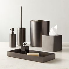 bathroom accessories including soap dispenser, toothbrush holder and tissue dispenser