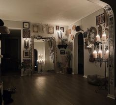 a living room filled with lots of furniture and mirrors