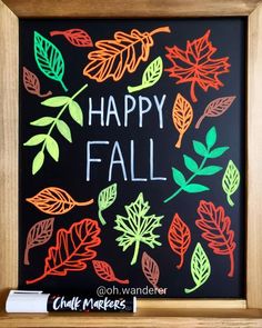 a chalkboard with leaves and the words happy fall written on it