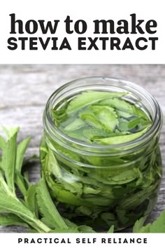 a jar filled with green leaves sitting on top of a wooden table