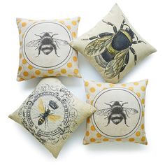 four pillows with bees on them