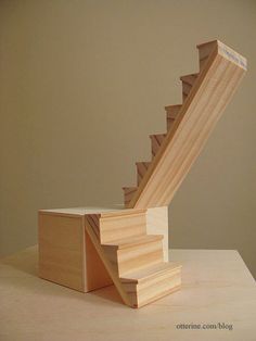 a wooden stair case sitting on top of a table