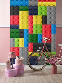 a bicycle is parked in front of a wall made out of legos