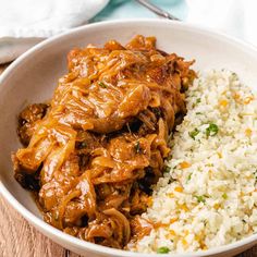 a white bowl filled with rice and meat