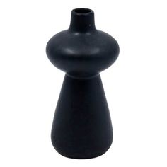 a black vase sitting on top of a white table