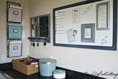 a black counter top topped with lots of drawers next to a chalk board and bins