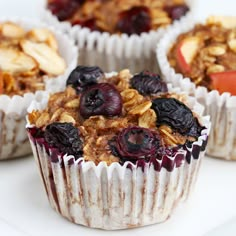 several muffins with fruit and nuts are on a plate