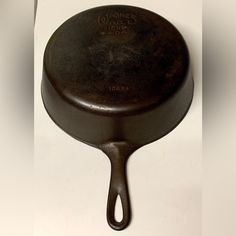 an old cast iron skillet with the word wonder time on it's side