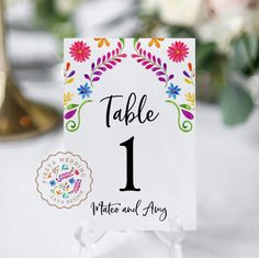 a table number card with colorful flowers on it