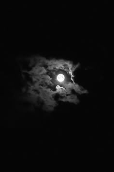 the full moon shines brightly in the dark night sky with clouds and black background