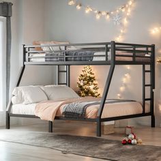 a bunk bed with a christmas tree in the corner and lights on the wall behind it